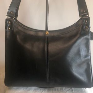 JOHN ROMAIN VINTAGE black shoulder handbag. Gold hardware with 5 feet at bottom.